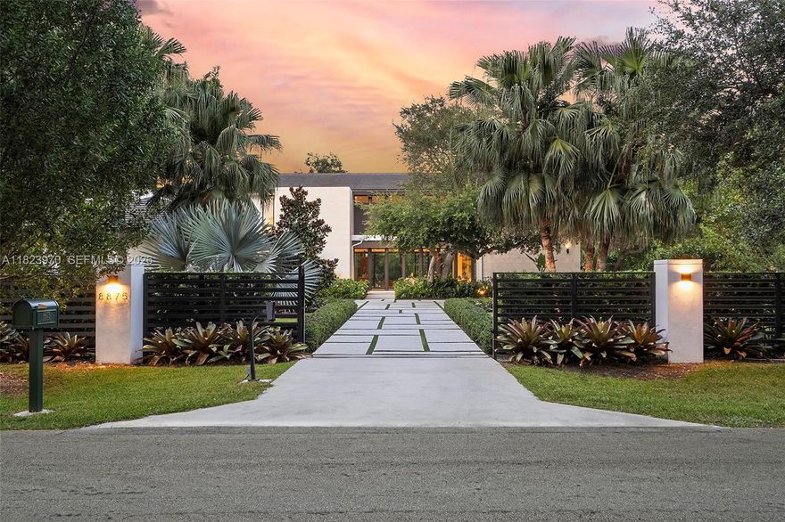 Welcome to Casa Paraiso – Immerse yourself in the most exclusive North Pinecrest lifestyle. This 2022 modern masterpiece sits on a 40,075 lot with 7,184 SF under A/C and 11,651 SF total. Enter through private gates and a long driveway to a stunning glass façade with soaring ceilings, rich wood millwork, and lush custom landscaping. The ideal layout offers 3 bedrooms on the first floor, formal living with fireplace, formal dining, Italian kitchen with Subzero/Wolf appliances, walk-in pantry, family room, service quarters, laundry, and elevator. Upstairs: primary suite with oversized closet, 3 bedrooms, den, and second laundry. Outdoors: resort-style pool/spa, covered terrace, oversized gazebo with summer kitchen, and room for a tennis court. Next to Miami’s best schools.