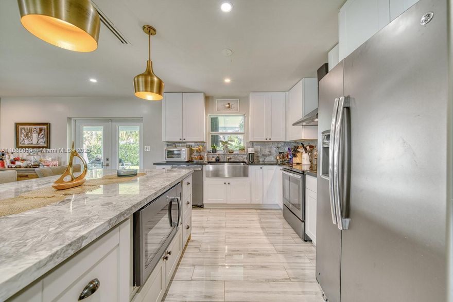 Modern 3-bedroom, 2-bath corner home in Palmetto Bay! Featuring a remodeled open-concept kitchen with stainless steel appliances, sit-in island, and built-in microwave and wine fridge. Many upgrades include Beautiful porcelain tile floors throughout a new roof installed in 2020, new water heater, covered aluminum terrace, and newer full-size washer/dryer. The converted garage adds flexibility, currently used as an office, with potential to bw used as in-law quarters. Set on an 8,500 sq. ft. lot with room for a pool, boat, or RV. Just 8 minutes to Black Point Marina and close to US1 and all that Palmetto Bay offers. All A-rated school district will ensure your families has the best education options from Kindergarten through high School. Easy to show by appointment.