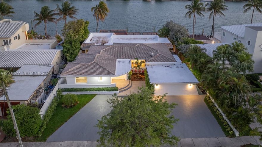 Enjoy waterfront living on Biscayne Bay in this one-story home located in the gated community of Biscayne Point. Set on a 12,000 SF lot with 80 FT of direct bay frontage, this property offers privacy, space, and open water views. The home features 4 bedrooms, 4 bathrooms, and approx. 4,315 SF of living area. Inside, the open layout is filled with natural light and upgraded with a brand new kitchen with custom cabinets and top line appliances, built for both daily living and entertaining. The primary suite offers a comfortable retreat with two walk-in closets and a brand new bathroom with a clean, modern finish. The home has been freshly painted and updated with new lighting throughout, giving it a sharp, move-in ready feel. Outdoor areas are designed for both relaxation and hosting. The pool has been resurfaced and includes brand new equipment and a heater. The large patio connects to an expansive approx. 1,811 SF private dock, one of the largest on the island, with direct bay access and open views, ideal for boating and sunset gatherings. Located minutes from the beach and the Bal Harbour Shops, this property offers a complete Miami Beach lifestyle. Move-in ready and fully upgraded, this home is a rare opportunity to own a true waterfront property in one of the area’s most private communities.