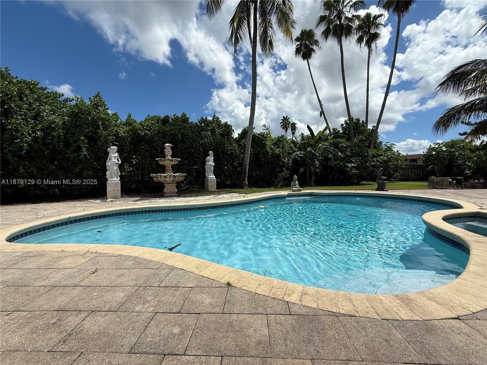 Beautiful single-family home featuring 3 bedrooms, 2 baths plus a den. Enjoy a spacious layout, new kitchen, updated bathrooms, and elegant porcelain floors throughout. The garage is currently an office but can easily be converted back if desired. Step outside to your private pool, surrounded by lakerfront and fruit trees, passion fruit, mango , avocado, papaya, coconut, lime and more. A circular paver driveway adds curb appeal and convenience. This home blends comfort, style, and outdoor living—perfect for relaxing or entertaining.