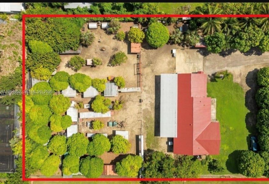 Discover the charm of country living with refined touches in this beautifully maintained Redlands estate, set on a sprawling 1.25 acre lot. This 3 bedroom, 3 bath residence blends farmhouse character with modern upgrades, offering both privacy and versatility.

From the moment you arrive, the home’s crisp exterior, distinctive red metal roof, and lush surroundings set a warm and inviting tone. Inside, the open layout is enhanced by elegant marble flooring, abundant natural light, and impact windows throughout. The kitchen is designed for both function and style, featuring rich wood cabinetry, granite countertops, and a spacious island ideal for everyday living and entertaining.

All bathrooms have been thoughtfully updated with sleek finishes, including glass-enclosed showers and contemporary tilework, creating a clean and modern feel.

Step outside to enjoy a covered terrace with exposed wood beams—perfect for relaxing or hosting. The fully fenced grounds offer endless possibilities, complete with chicken coops, multiple enclosures, and over 20 fruit trees including mango, avocado, and citrus varieties.

Additional highlights include a 2 car garage, an expansive driveway accommodating 10+ vehicles, and ample space for an RV or boat.

A rare opportunity to enjoy space, privacy, and lifestyle all while being just minutes from city conveniences. Easy to show.