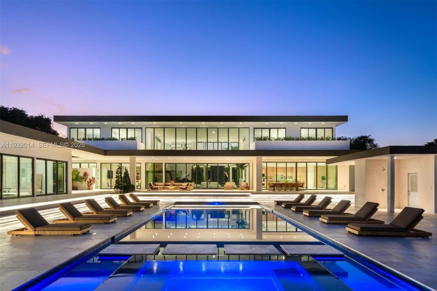 An extraordinary modern estate within Southwest Ranches, this palatial modern mansion sits on 3.3 acres and is an architectural masterpiece with an exceptional floor plan and resort style backyard. Where modern meets nature, this private retreat is perfect for entertainment & accommodates a large family with an expansive lifestyle. With over 15,000+ sq. ft of total space and soaring high ceilings, customize to your needs with 6 beds + office in the main house, a 2bed guest house, 4 car garage, detached gym, multi-sport court, huge pool terrace with fire pits & built in bar, & outdoor kitchen. The expansive backyard offers a unique opportunity to add on to the property. Fortified with a double electric gated entry & privacy wall, 17841 is the embodiment of grandeur and sophistication.