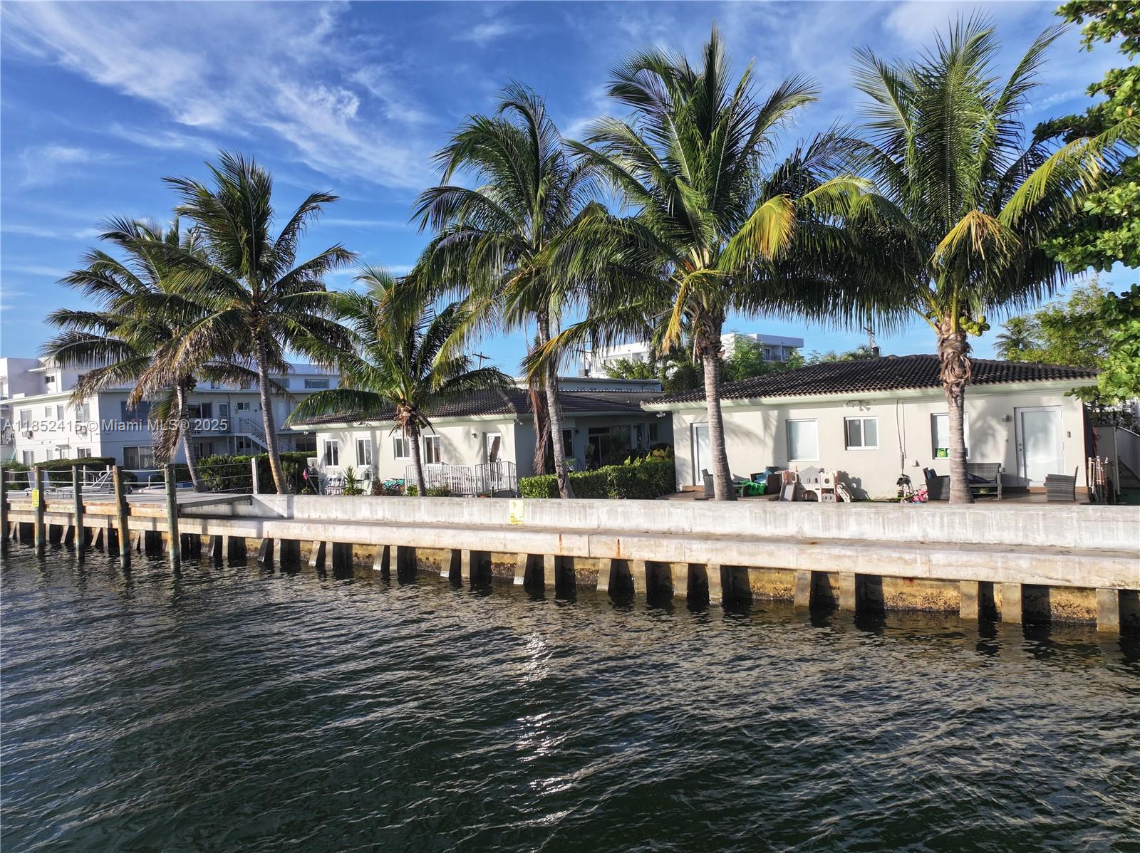 Investor Opportunity: Normandy Island. Enjoy stunning sunsets from this private 2-bed/2-bath, split-layout unit located on Bay Drive West, nestled on a quiet, no-outlet street. Rents for $3,500/month +/- fully renovated, or can be leased as-is for \$2,500/month +/-. Possible future developer land play opportunity with two 4-unit, single-level buildings and a two level building with 18-units, totaling 26 units. The entire property sits on approx. 35,000 SF of prime land with an impressive 220 feet of Biscayne Bay frontage. With $2 billion + in new construction underway in the area. Additional; low monthly maintenance, new seawall, dock, and pool, and the building has successfully passed the 40-year recertification, ensuring structural integrity and compliance. Near Golf, tennis & kid parks.