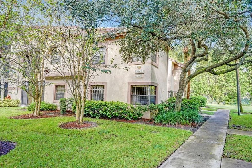 Beautifully updated corner unit! Located on 1st floor in charming community of Optima Village in Fountain Spring. Nestled in back of complex. Being Sold AS-IS. No stairs! All ages! Small storage closet at front door. Pets welcome under 20 lbs. Unit is a total of 1,422 sq. ft. which includes glass enclosed patio w/ceramic tile to create extra living space. Open kitchen features: wood cabinetry, granite countertops, recessed lighting, SS appliances. Split BR floor plan. NO carpet! Ceramic tile and wood laminate. Newer front load Samsung washer/dryer.  1-assigned parking + guest. Roof redone 2018. Resort style pool w/ lap lanes, kids pool, hot tub, clubhouse. Can rent immediately: TENANT IN PLACE UNTIL DECEMBER 10, 2026. NO AIRBNB OR SHORT TERM RENTALS PERMITTED. Walking distance to Deicke Park (adjacent to Fountain Spring). Park offers tennis, volley-ball, 1/2 mile walking trail + more! Room sizes listed. 700 credit score required per HOA. Optima Village is centrally located and a well-maintained community known for its serene environment & family-oriented atmosphere. It offers proximity to Sawgrass Mills Mall, dining, casinos and major highways, making it convenient for commuters. Fort Lauderdale Beach is only about a 20 minute drive east! Association fee is $1,560.37 quarterly plus $270 quarterly to Master Assoc. (total of $1,830.37 per quarter). Assessment for the 25 year building recertification and restoration has been paid in full.  CLICK ON VIRTUAL TOUR TO SEE VIDEO!