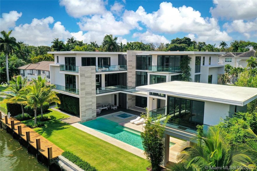 Spectacular contemporary 6 bedroom / 6 1/2 bath Coconut Grove waterfront house, with independent guest house. This 2017 new construction sits on a peaceful waterway, 600 feet from Biscayne Bay, in the private & guard-gated community of Entrada estates. Enjoy the luxury of living on the water, in a peaceful community where neighbors share a tennis court & a small dog park at the end of the road. The house offers large volumes, high ceilings, & abundant natural light pours in. The high windows offer views on the lush tropical landscaping, & waterway. The house is equipped with an elevator, an inside & outside sound system controlled with the same panels as security & A/C throughout the property. The floors are a combination of polished stone in common areas & wood in the bedrooms.