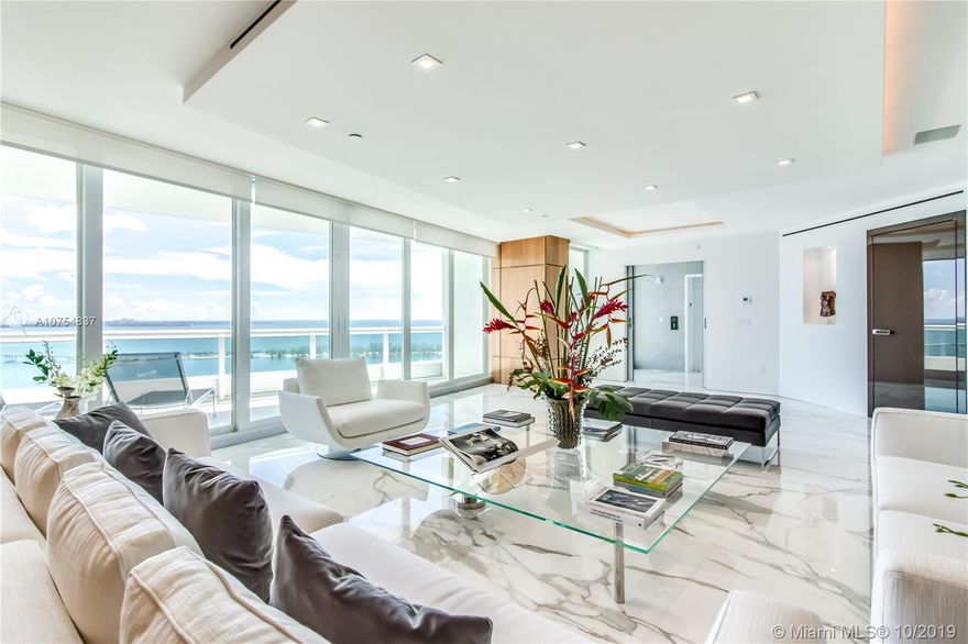 Outstanding renovation and re-design for this remarkable residence. The private foyer opens to a sun filled, flow thru living area offering views of the water and the City. High impact doors and windows, high ceiling with custom design and lighting. Poliform kitchen & baths. Calacatta gold marble & noce wood floors, Poliform custom paneling, master suite with his/her closets and his/her bath, 2 additional superb en suite bedrooms & staff service area. Large terraces on either side. This is truly a one of a kind unit.