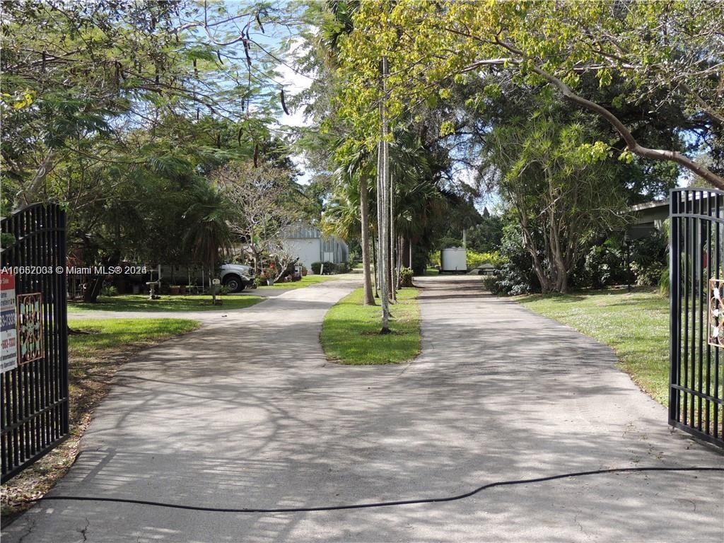 RENTAL EXPIRED BACK ON MARKET! HUGE 2.4 acre lot centrally located in Davie! Property is zoned A1 and currently has a 2 structures on it. Structure one is a single family home that needs complete rehab or teardown. Structure 2 is a concrete detached garage. Property has several palm trees and is located next to a huge lake! Several recent developments in the area and even next door. Plenty of potential! Existing house can be rehabbed or knock it down and build your dream home.