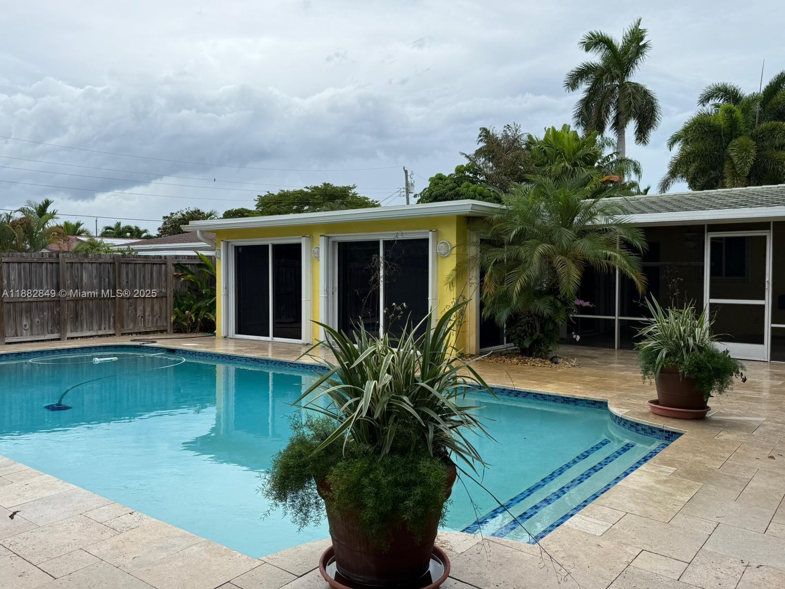 Furnished home, minimum rent 6 months, then can be month to month. Located in the desirable Coral Heights neighborhood of Oakland Park, this home offers ultimate privacy with lush tropical landscaping and a spacious 20x20 Florida room featuring 4 sliding glass doors overlooking the large diamond-brite pool (2019) with travertine deck (2019). Recent upgrades include flat roof (2024), impact garage door (2025), impact front/back doors, accordion shutters, and PVC/pvc-lined plumbing. Other highlights: outdoor hot/cold shower, generator bypass, updated pool equipment (2023), central AC (2020), and insurance credits for protected openings. Just 1.5 miles to the beach!