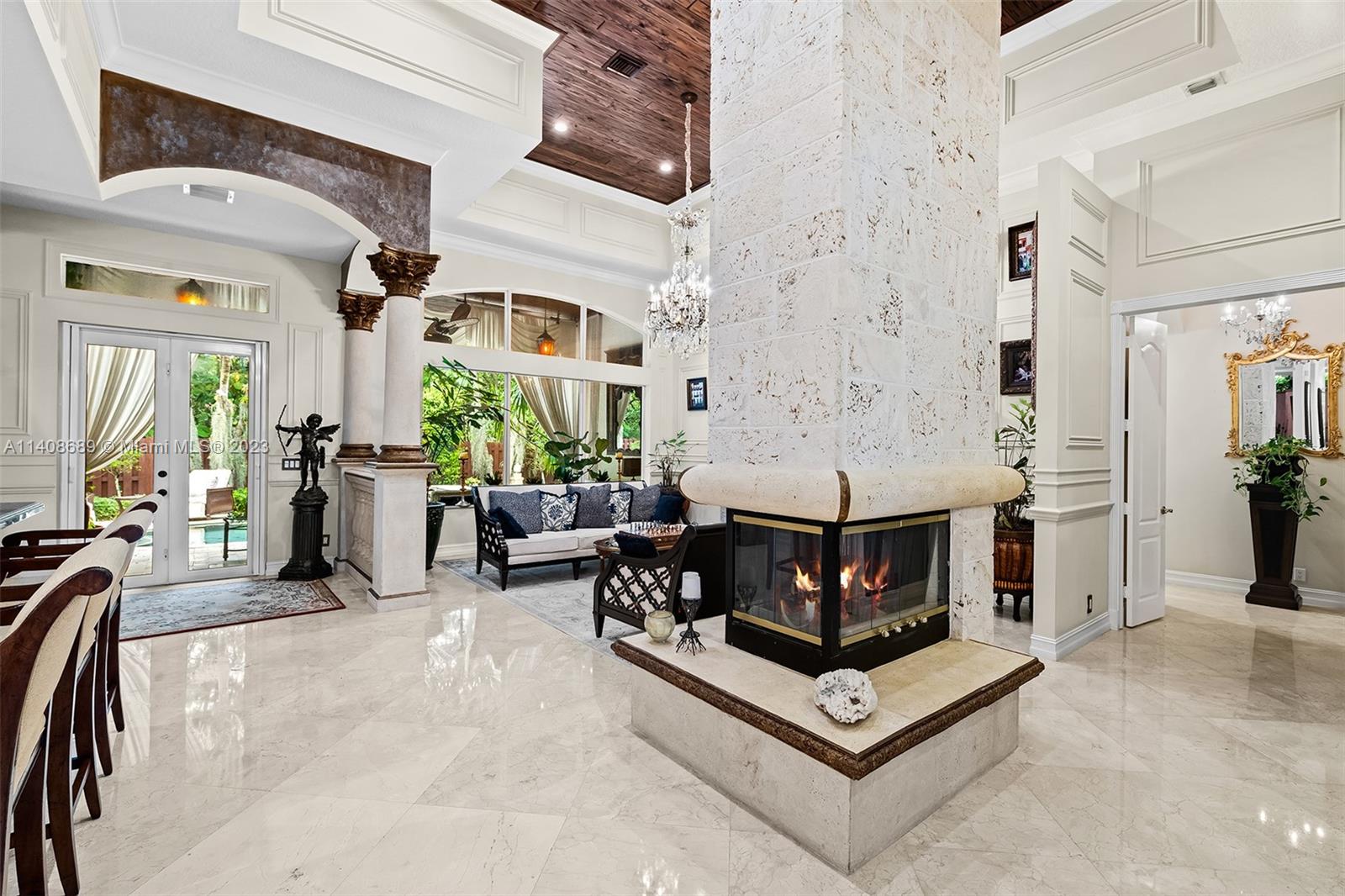 Welcome to the stunning Mizner inspired Mediterranean home, where soaring cathedral ceilings and a floor to ceiling coral stone fireplace create an enchanting ambiance. Located in Ocean Ridge, this well-appointed 4 Bed, 3.5 Bath residence is steps from a private deeded beach and adjacent to a magical nature preserve, ensuring ultimate seclusion. The custom home office with beautiful woodwork, a murphy bed, and built-in closets offers optimal functionality and can easily convert to a fifth bedroom. The open concept floor plan provides privacy with a guest wing, tiled two-car garage, and separate primary suite. Outside, the marble mosaic pool and limestone terrace await, inviting you to relax and unwind. Experience coastal living at its finest in this architectural masterpiece.