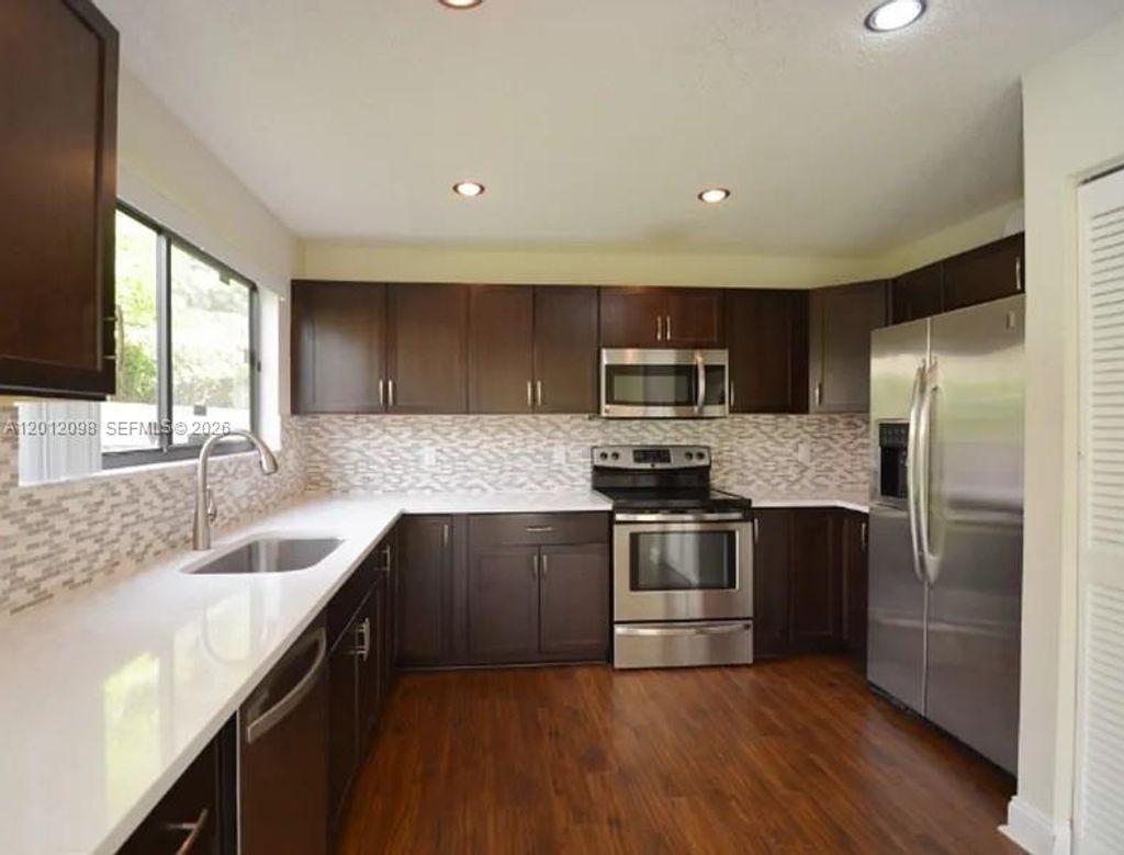 Photo of 587 NW 38th Ave, Deerfield Beach, FL 33442 (MLS # A12012098)
