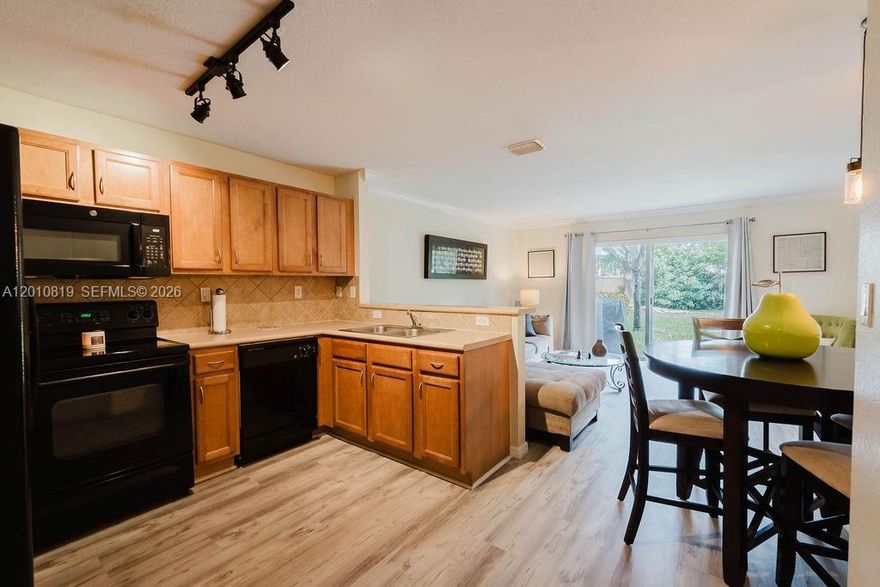 This beautifully cared for 3 bedroom 3 bath corner townhouse has been lived in by only the original owner and perfectly maintained since day one. Located in a desirable gated community in Miramar with low HOA fees and 24 hour security, this home offers excellent flexibility for primary residents and investors alike. The smart functional layout features a first floor bedroom and full bathroom, perfect for guests or extended family. The open concept kitchen flows seamlessly into the main living area and includes generous cabinetry, a pantry, and plenty of natural light throughout the home. Upstairs you will find a spacious primary suite complete with two walk in closets, an ensuite bathroom, and a private balcony. This property stands out offering a private, safe, and ample backyard with no rear neighbors for added privacy and enjoyment. Residents enjoy access to outstanding resort style amenities including a pool, fitness center, clubhouse, and playground. The HOA covers cable, internet, trash, sewer, property insurance and roof maintenance. Conveniently located near I 75 and the Turnpike, this home is just minutes from shopping, dining, top rated schools, parks, and everyday conveniences.