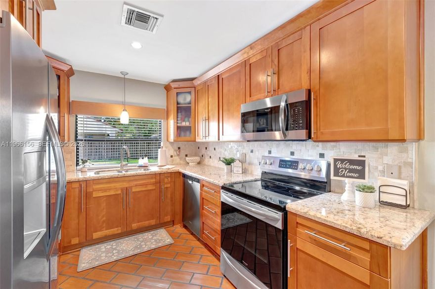 Your future home awaits! Welcome to this charming corner lot home in the highly sought-after Rock Creek community in Cooper City; known for its fantastic schools. This home features a beautifully renovated kitchen with granite countertops, large pantry, two glass cabinet doors, elegant tile backsplash & kitchen window with passthrough to back patio and pool area. Spacious primary bedroom features flowing natural light, and walk-in closet. Primary bathroom features double vanity, large tub, step-down shower with glass doors, NEW water-resistant floors in modern style. Enjoy high ceilings & a spacious living & dining areas, along with a renovated 2nd bath. Flooring includes terracotta brick & laminate throughout. Step outside to a private pool & great backyard with a covered space, perfect for relaxing & entertaining. Additional features include new washer, paver driveway, Ring camera, hurricane panels, impact front door & new impact garage doors, cement slab perfect for a shed. Tile roof 19 yrs old in great condition. Access to Cooper City Pool and Tennis Center. A place to truly feel at home.