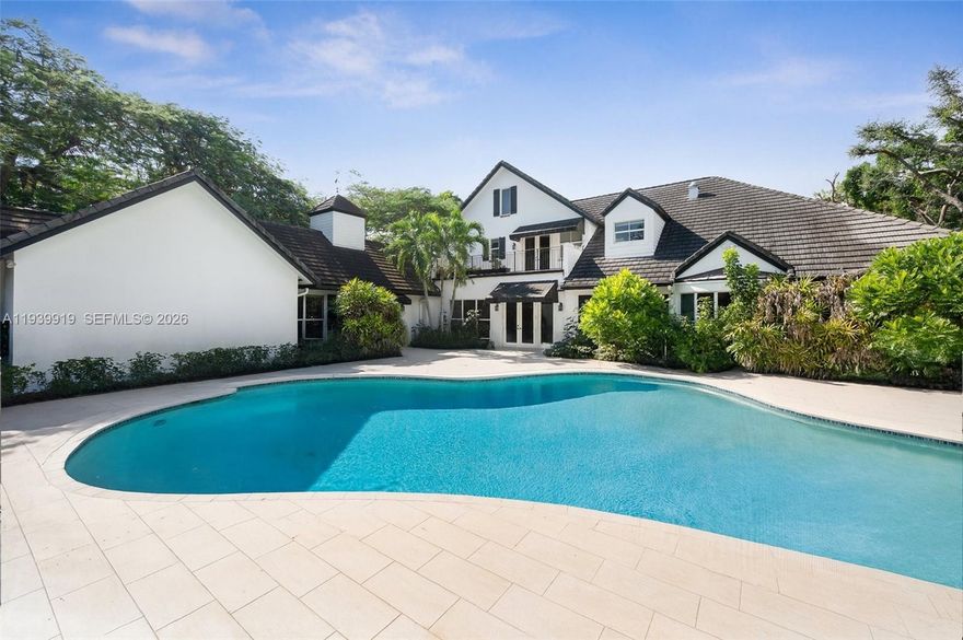 Elegant, newly refreshed Hamptons-inspired Northeast Pinecrest estate offering 7,900+ sq ft on a 0.98-acre street-to-street lot. Located near South Florida’s top public and private schools, the home features 5 en-suite bedrooms, 8 baths, and 3 additional rooms currently used as a gym, theater, and studio. Soaring ceilings and impact glass fill the interiors with natural light, and the chef’s kitchen with a butler’s pantry is ideal for entertaining. The primary suite includes a spa bath and expansive custom closet. Outdoors enjoy a heated saltwater pool, pergola, BBQ gazebo with cabana bath, and lush landscaping. The property is gated and supported by neighborhood patrol, includes an elevator, generator, and abundant storage closets.