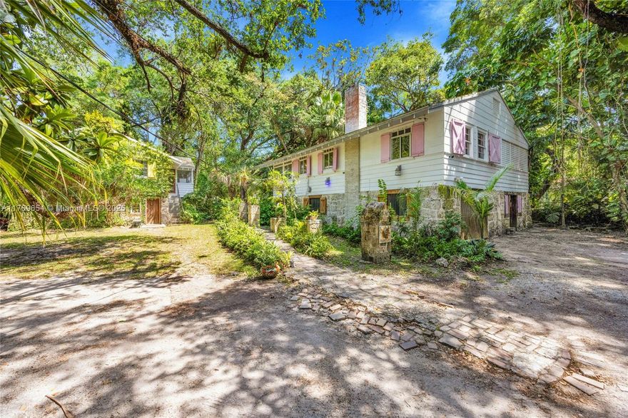 Set on nearly 1 acre (42688 sf with 2 folios) of tranquil, tree-filled land, located in the guard-gated Banyan Lakes neighborhood adjacent to Snapper Creek Lakes on Arbor Lane. This property combines lush greenery and abundant space for expansion. Surrounded by mature trees, including oaks, royal palms, & gumbo limbo, the lot provides a serene and private atmosphere. 2 historic vernacular Craftsman-style cottages at the back of the property add character. The cottages offer endless possibilities as guest houses, rentals, or creative spaces. You may be able to add to the existing cottages or potentially build a new structure, subject to approval by Coral Gables.