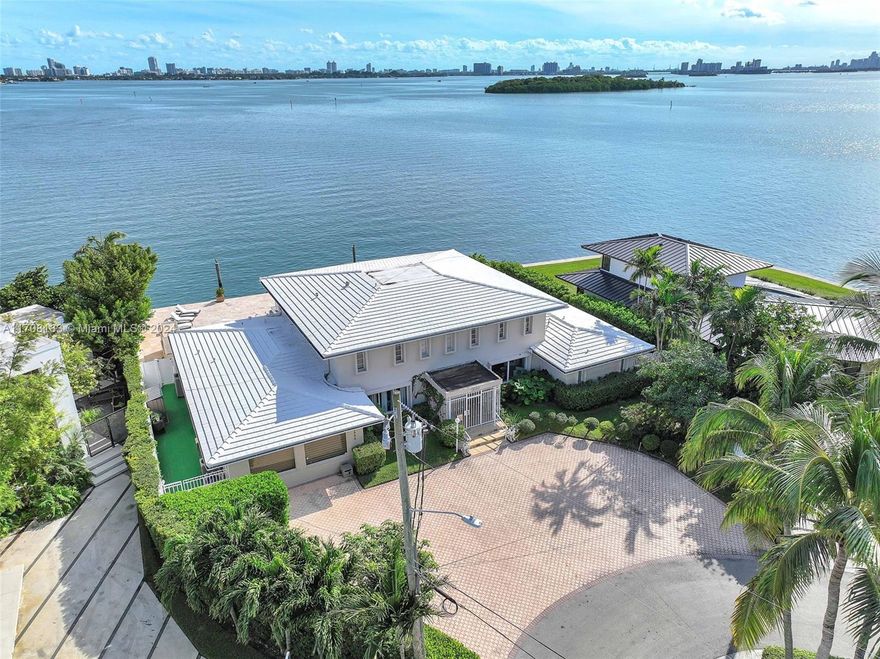 Timeless elegance and effortless charm surround you from the moment you enter this classic bay front home. Situated on a 13K s/f point lot with unobstructed and unmatched direct bay views, this 7 bedroom 5 full bath residence is a must see. This unique property has been home to one owner for the last 5 decades and has been meticulously cared for and updated over the years. Home features many recent upgrades such as whole house impact windows, updated baths, updated salt water swimming pool, custom closets, fully remodeled primary ensuite just to name a few. This home is a must see for anyone who appreciates the warmth and inviting atmosphere of understated elegance and comfort in an unparalleled location or those seeking a canvas to paint their own masterpiece on this one of a kind lot.