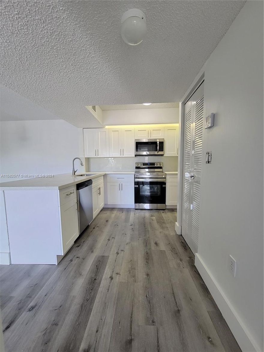 Beautiful & cozy condo completely remodeled and located in a desirable gated community. Spacious apartment with living & dining room, double closet, balcony and laundry inside the unit. Kitchen with extra pantry and breakfast nook. Laminated floors throughout. Parking included. Amenities include tennis court, park, playground, BBQ area, pool, exercise room and much more.