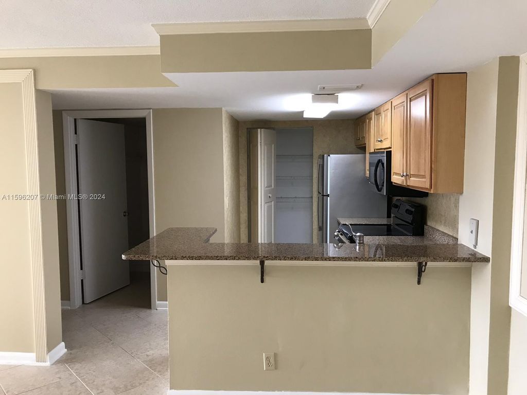 Photo of 10709 Cleary Blvd #106, Plantation, FL 33324 (MLS # A11596207)