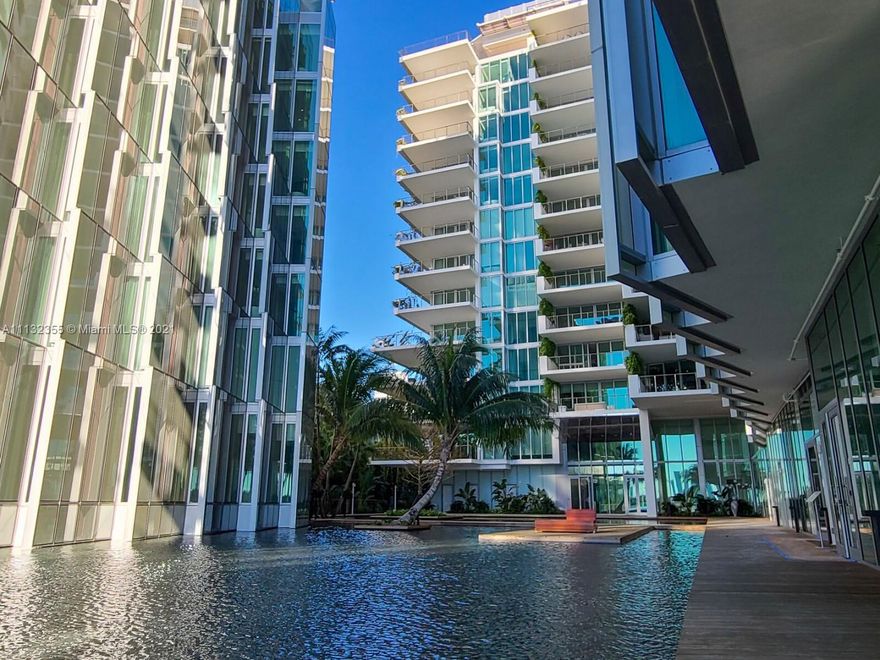 Composed of 59 individually designed waterfront residences around a glittering lagoon, Monad Terrace  provides brilliant light, private outdoor space, climbing gardens, unique sawtooth honeycomb facades; stunning sunset views of Biscayne Bay. Kitchens with dramatic sculptural marble island. Master baths with richly veined, spacious stone countertops, marquetry flooring and tiled walls. Other notable features include custom cabinetry &amp; built-in features, designer fixtures, teak flooring throughout.This is a stunning, light-filled floor plan, 3 bedroom 3.5 bath condo with 2691 internal sq. ft. and an expansive wrap around 1800 sq. ft. terrace. The unit also features a private elevator entrance and 2 assigned underground parking spaces.