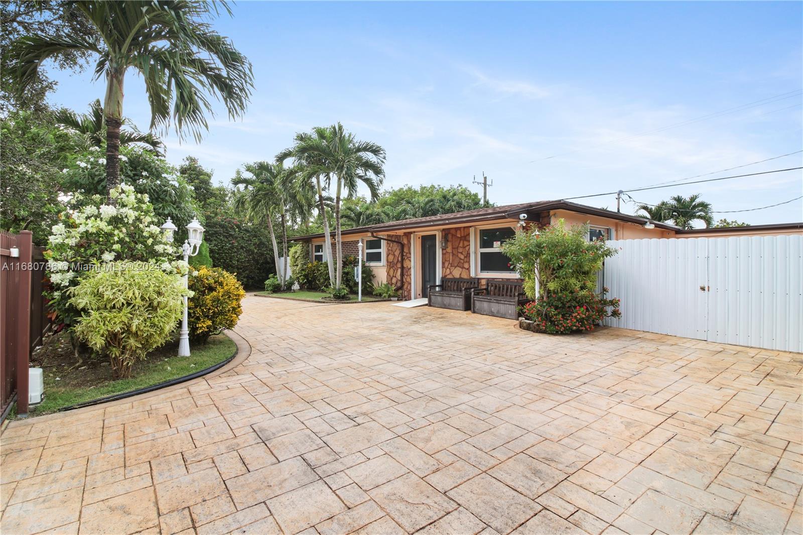 Discover this charming corner home in Cutler Bay, featuring 3 spacious bedrooms and 2 bathrooms—ideal for families or entertaining guests. With a new roof and gated entrance, you can enjoy both security and peace of mind. The circular driveway offers convenient parking, while the expansive Florida room provides an excellent space for gatherings and entertaining. The lush backyard serves as a tranquil retreat, complete with an outdoor shower for added relaxation. This attractive home is a wonderful opportunity in a desirable neighborhood. Don't miss out!