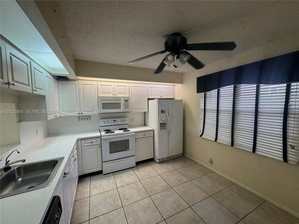 Photo of 1200 SW 125th Ave #208L, Pembroke Pines, FL 33027 (MLS # A12022869)