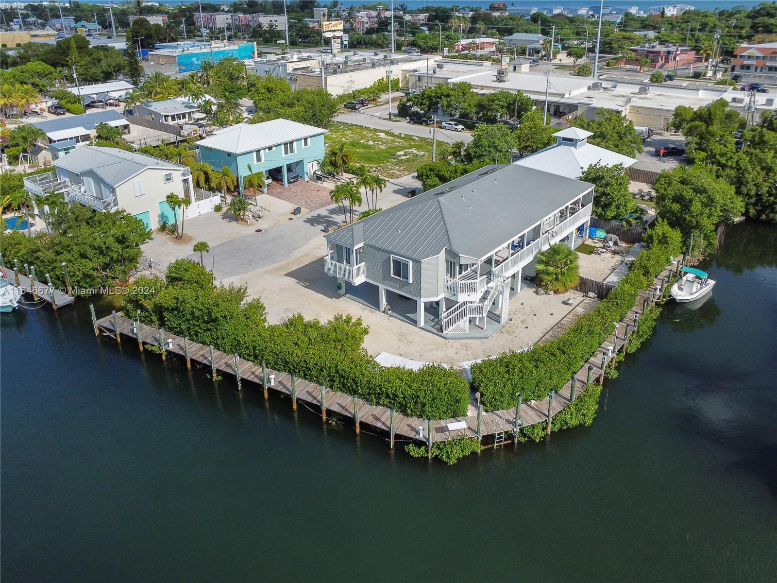 Luxury Living OR Business Opportunity! This Gorgeous Vacation Home Offers A Highly Profitable Business & Tranquil Retreat From The Bustling World. Waterfront Views Are On Full Display In The Deep Sea Fishing Capital Of The Florida Keys! Completely Furnished, Turn Key, Short Term LICENSED Vacation Rental Offers Rarely Available 174 ft Dock AND Semi Private Boat Ramp. Plenty of Space for MULTIPLE BOATS OR YACHT. Garage with huge storage space with electric. This Impressive Home Sits On A Wide Canal With Access To The Ocean. Stunning Water Views Boasting a Remarkable 6 FIGURE INCOME Annually. Also Boasting Those Breathtaking Waterfront Views! All 3 Large Bedrooms Offer Ensuite Bathrooms and Plenty Of Storage. Paradise is waiting for you here in the beautiful Florida Keys!