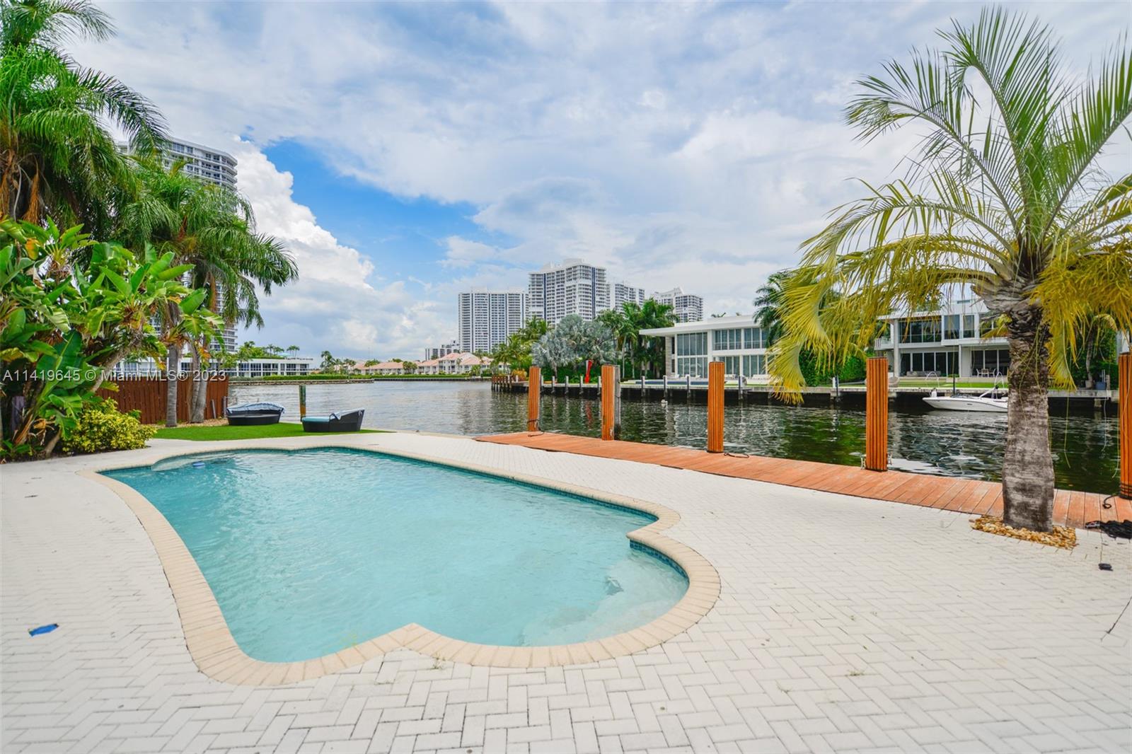 YACHTSMAN DREAM!!! UNIQUE CUSTOM-BUILT INTRACOASTAL FRONT HOME IN EXCLUSIVE GATED GOLDEN BEACH. LOCATED ON CUL-DE-SAC WITH APPROXIMATELY 120 FEET OF WATER FRONTAGE W/DOCK AND OCEAN ACCESS. SPACIOUS 2-STORY, 4 BED AND 4 BATH HOME, VAULTED CEILINGS, AND A 2- CAR GARAGE. WITH HIGH IMPACT WINDOWS AND DOORS THROUGHOUT, A REMODELED KITCHEN, AND A LARGE HEATED POOL. HOME HAS 2 MASTERS: GRAND MASTER SUITE UPSTAIRS COMPLETE WITH PRIVATE BALCONY OVERLOOKING THE WATER AND REMODELED BATHROOM. 2ND MASTER LOCATED DOWNSTAIRS WITH A SEPARATE DOOR TO THE POOL. LARGE EAT-IN KITCHEN. THE HOME IS FULL OF STORAGE & BUILT-IN CLOSETS. WALK TO THE PRIVATE BEACH & TENNIS COURTS. DON'T MISS THIS OPPORTUNITY TO OWN THIS GREAT HOME IN THIS SPECIAL COMMUNITY.