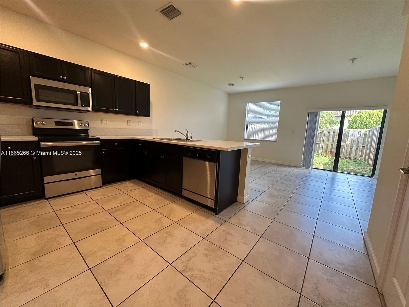 The beautiful community of Coco Palm Estates in Homestead, FL has a 2-Story Townhouse move-in ready! Property features: Tile flooring throughout on first floor, and brand-new laminate flooring throughout the second floor. Open kitchen concept with stainless-stee appliances and wood cabinetry. Washer and Dryer on second floor and half a bath on the first floor. Spacious patio with artificial grass and no back neighbors. Community offers pool, gym and clubhouse. Location is ideal, close proximity to supermarkets, shopping centers, schools and highways.