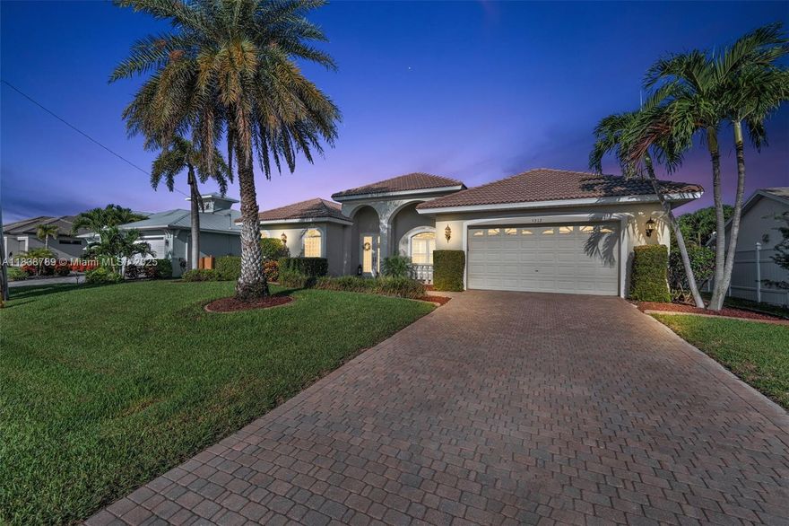 This beautifully updated Gulf-access home offers direct, bridge-free boating with a private dock and lift—ideal for coastal living. Located in one of Cape Coral’s top waterfront neighborhoods, the expanded floor plan enhances its open feel, perfect for entertaining or everyday comfort. Inside, enjoy high ceilings, plantation shutters, a cozy propane fireplace, and abundant natural light. The freshly painted interior features a split-bedroom layout, new carpet, and ample storage. The kitchen showcases cherrywood cabinets, elegant granite countertops (2023), and a functional layout, with matching bathroom upgrades. The primary suite includes a Jacuzzi tub for ultimate relaxation. Step out to a west-facing lanai and oversized, resurfaced pool (2024), surrounded by updated pavers (2022).