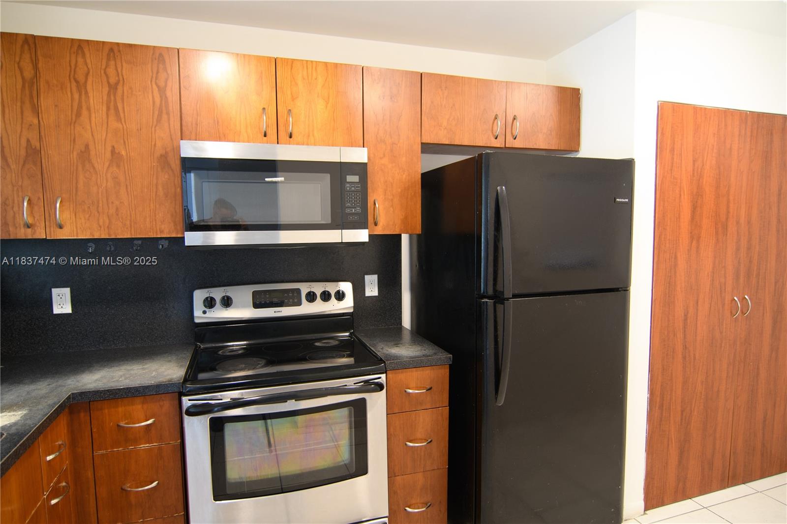 Charming, spacious and bright 2/2 condo in a gated community. Ideally located near I-95, US-1, Aventura Mall, and the beach. Pet-friendly, all-ages community offers the perfect mix of convenience and comfort. The unit features a functional kitchen waiting for your creative updates, tile floors throughout, in unit washer dryer, and a screened-in patio. Main bedroom includes an ensuite bathroom and walk-in closet. With one assigned parking spot and plenty of guest parking, this condo is both practical and inviting. Low HOA fees, no rental restrictions. Investor or a first-time buyer- this is a great value with lot of potential.