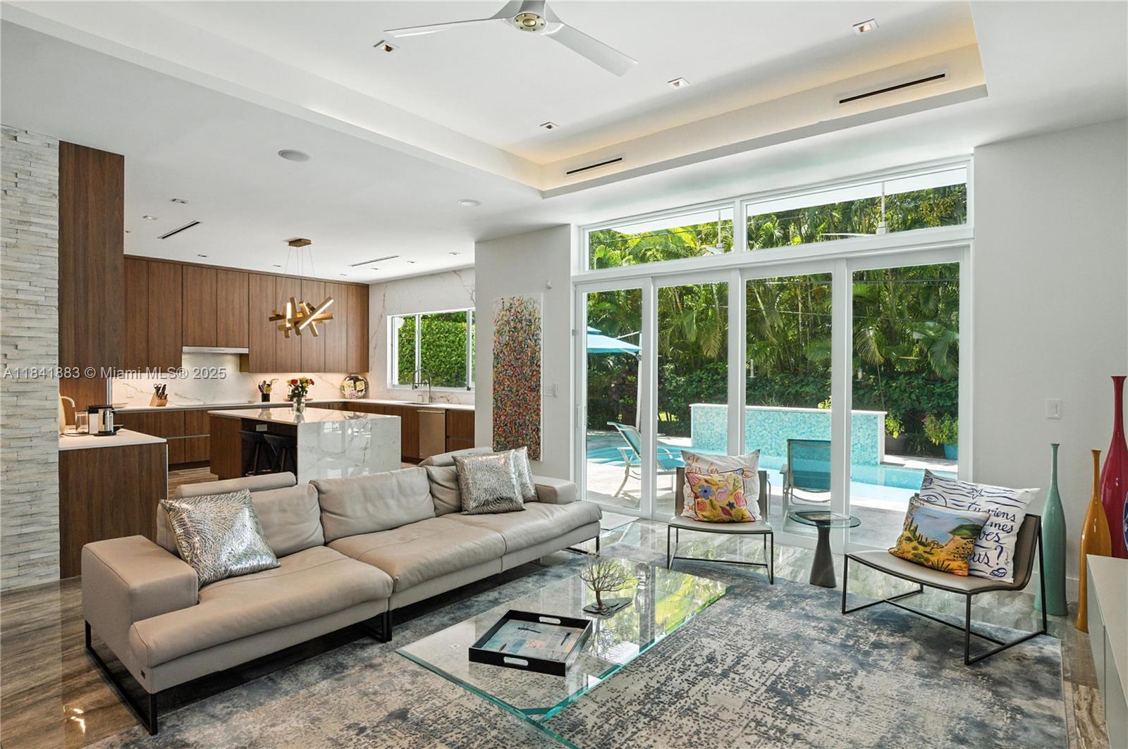 A modern home located in one of the best streets of South Coconut Grove! Quiet and charming while conveniently able to walk to the center of the village or the best private schools! This, 4-bedroom, 3.5-bath architectural gem with soaring 24 ft ceilings, sleek finishes, and a light-filled open layout. A fully remodeled kitchen, upgraded custom doors throughout. Expansive primary suite with renovated spa-style bath and oversized walk-in closets!! Additional highlights include a private office in addition to the 4 bedrooms, artful decor, and a 2-car garage. Gated, secure, and ideally located. A true modern sanctuary.