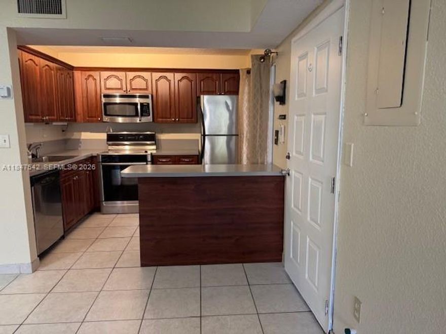 LOCATION! Freshly painted, low price Quatraine! Beautiful, serene garden view. First floor corner, 2/2 split plan, screened patio, SS appliances, ceramic tile throughout w/carpeted bedrooms, 3 ceiling fans. Ample closets, extra storage on patio, full size washer/dryer. Maintenance includes water, cable TV w/HBO, 24 gated entry w/guard, on-site management, heated pool & spa.  Small pets OK. Minimum credit score 675, minimum 5% cash down. No seller concessions. Price is firm.