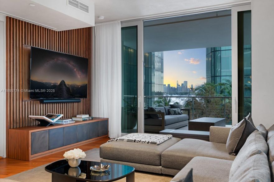 Step Inside With Me! A statement in contemporary design, this designer flow-through corner residence showcases water views and an ideal floorplan. Past the private foyer, curated interiors reveal a grand salon with 10' ceilings, wood floors, custom millwork, bespoke bar, wine wall and wood paneling enhanced by Lutron lighting and automated shades. The chef’s kitchen pairs Calacatta marble with Gaggenau appliances beneath a teak canopy. The primary suite features a Poliform dressing room and spa bath with soaking tub and rain shower. Telescopic glass walls open to a 1,795 SF wraparound terrace with hanging gardens and East/West exposures. This Jean Nouvel 59-residence enclave offers tranquil lagoons, fitness studio, 24hr security, valet, 100’ pool - all just minutes from Sunset Harbour.