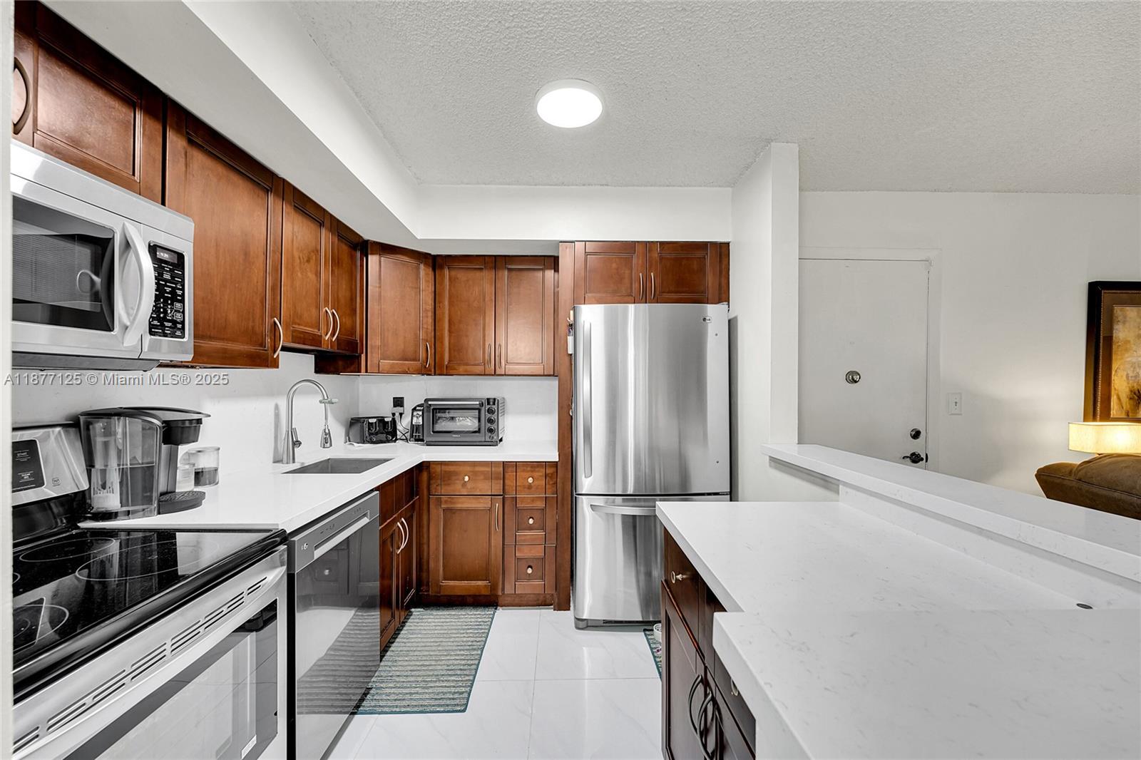 Just gorgeous 2 Bedroom 1 Bedroom condo. 1st floor location and a corner. This condo features all impact windows, new air conditioner and compressor with a 10 year warranty. New bathroom vanity, toilet, and shower, new water heater, New garbage disposal, newly painted interior, new dishwasher, new quartz counter tops. New dinette and storage cabinets included. New flooring throughout including the patio. New closet doors. Laundry room on patio with full size washer and dryer. Ready for a new homeowner to make it their own. Enjoy living in the beautiful Clairmont-Kings Point.