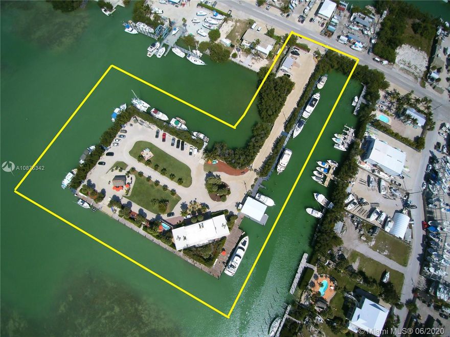 Wow! This is a private Island Oasis in Marathon, on Bonefish Bay. First time offered for sale in 25 years. The island has 1.75 Acres w/ approx. 1,200 lineal ft of deep draft boat dockage. 27 wet slips permitted, each with electric meter. Can accommodate up to 110' yachts. Also has boat ramp. Gorgeous 4,500 sf. single family waterfront 3bd/2.5 ba home is solid CBS/concrete slab & ceiling construction w/ Generator. 2 market rate RES units recognized. 3 Buildings, Men's/Women's shower room & Storage building. AE Flood Zone. Partial Baybottom owned & other leased from State. Connected to CoCoPlum Dr. with private gated entrance & 30+ parking spaces. Zoning is MU, Mixed Use allows for many commercial uses incl. Multi Unit Residential, Yacht Club & Marina, Boat storage & racks, and much more
