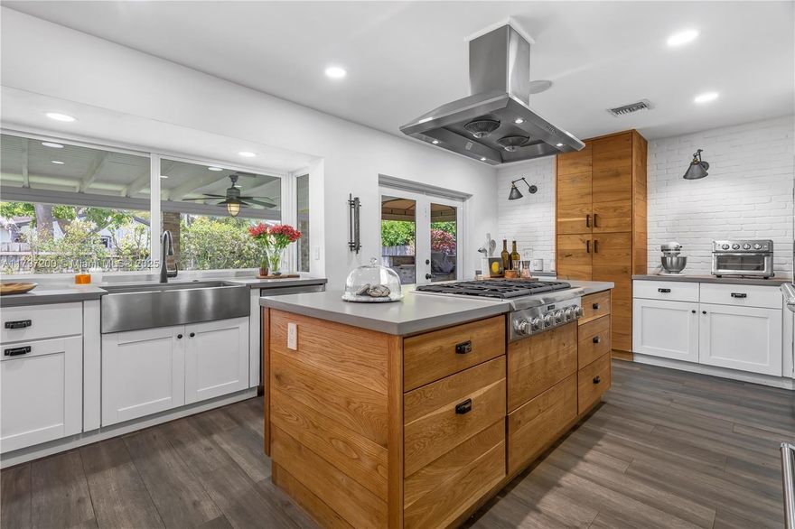 Come see this meticulously remodeled Darlington Manor gem! This spacious 4-bedroom 2-bath home features a spectacular, modern kitchen with gorgeous countertops, wood cabinets and SS appliances. It has a split bedroom plan with plenty of closets plus a garage with new steel door connected to WIFI and back-up battery. Some features are porcelain floors, window treatments, impact windows and doors, Sonos entertainment system, a new central A/C, and much more. Enjoy a large, private, covered terrace, a summer kitchen with natural gas BBQ, and a wall-mounted TV for entertaining. It sits on a spacious walled/fenced corner lot with plenty of room for boat on the side of house & pool in backyard. Location is accessible to wonderful schools, restaurants, shopping, and transportation. A must see!