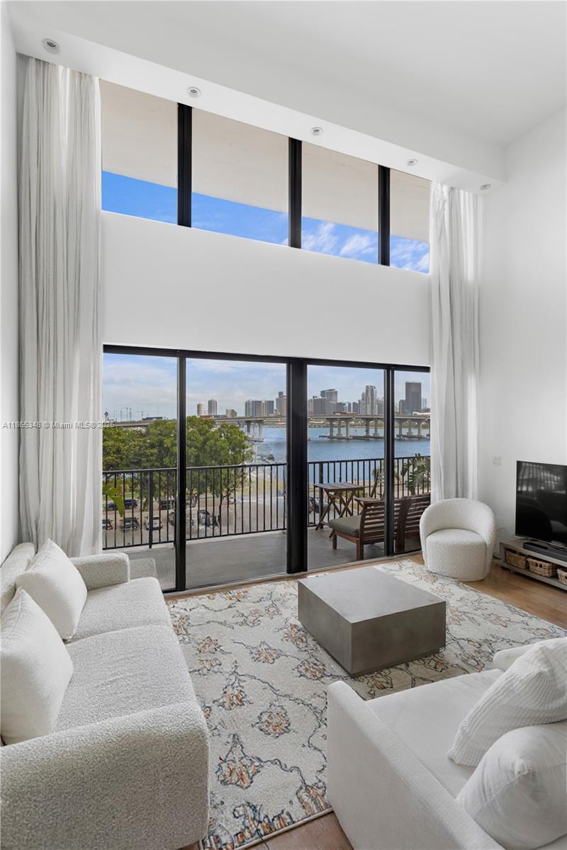 Spectacular 1.5-story oceanfront apartment with 3 bedrooms, 3.5 bathrooms, and over 1,800 sq. ft. on the Venetian Islands offering unobstructed views of Biscayne Bay, the Port of Miami, and the Miami skyline. Outdoor terrace extending from the living room and downstairs bedroom, plus a private balcony from the primary suite. Living room with soaring 18-foot vaulted ceilings and floor-to-ceiling windows. Building amenities include tennis court, pool and deck area, new social lounge, and newly built fitness center. Guard-gated entrance. Ideally located just minutes from top restaurants, shopping, Brickell, pristine beaches, Wynwood, Edgewater, and Miami International Airport.