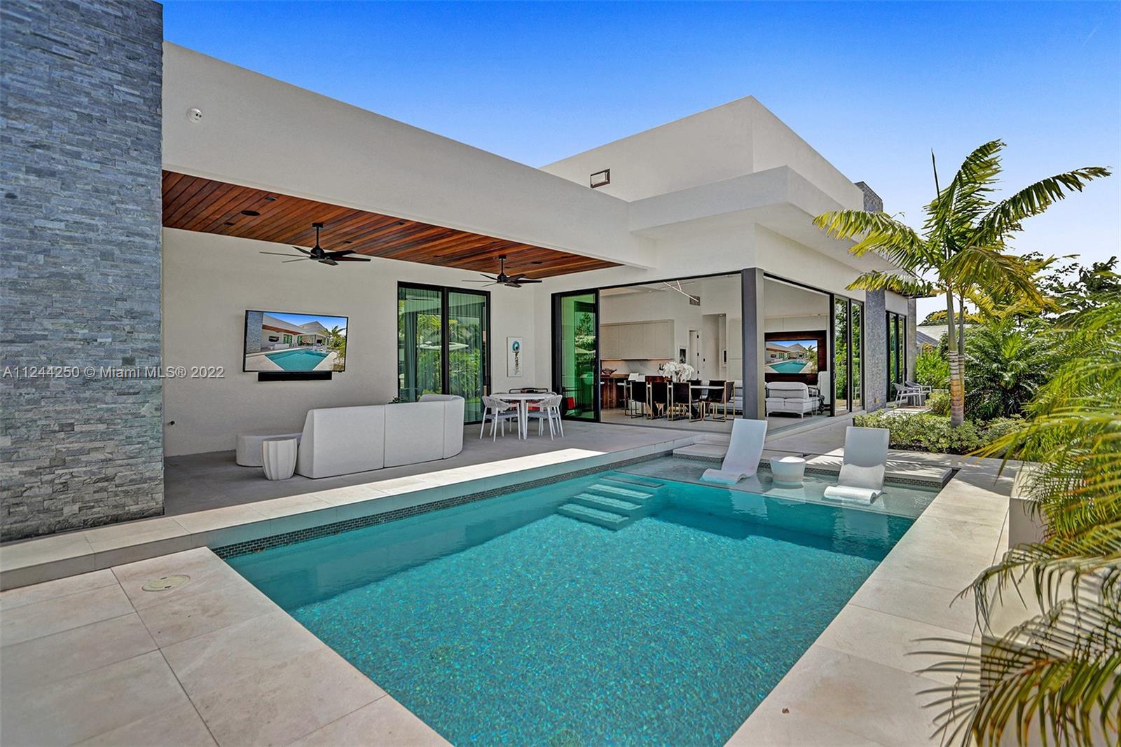 Beautiful newly constructed modern waterfront property on one of the widest canals in the sought after Coral Ridge area. New 2021 100FT concrete dock & seawall. 14ft ceilings, 10ft panoramic sliding glass doors, pool, covered patio, and outdoor covered kitchen. Inside you will find a European style kitchen designed by DOCA w/ Sub Zero and Wolf appliances w/ gas range. Outside has a luxury Blaze grill, refrigerator, ice maker, and sink. 220V car charger in garage. Ocean access, seconds from the Intracoastal & waterfront restaurants. Recent upgrades: heated salt water pool, upgraded Sonos stereo system, custom built bar & entertainment center, custom linen curtains, chandeliers, blackout roller shades in all bedrooms.