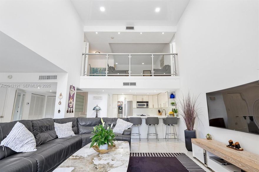 Enjoy the Space of a House at a Condo Price in Prime Aventura. This beautifully remodeled 2,500 sq ft townhome-style residence features vaulted ceilings, oversized windows, and abundant natural light with peaceful golf course and water views. The open-concept kitchen offers modern finishes, ample storage, and flows seamlessly into the living and formal dining areas—ideal for both entertaining and everyday living. The layout includes 2 split primary suites with sitting areas, 3 full bathrooms, and a versatile den that can easily be used as a 3rd bedroom or office, along with 3 private balconies. Additional highlights include a new A/C, new water heater, and covered garage parking space just steps from the entrance. The community offers a heated pool, fitness center and spa for added comfort and convenience. Located in the heart of Aventura, within walking distance to Aventura Mall, dining, shopping, parks, and top-rated schools.  Ideal for a primary residence or second home. Move-in ready!