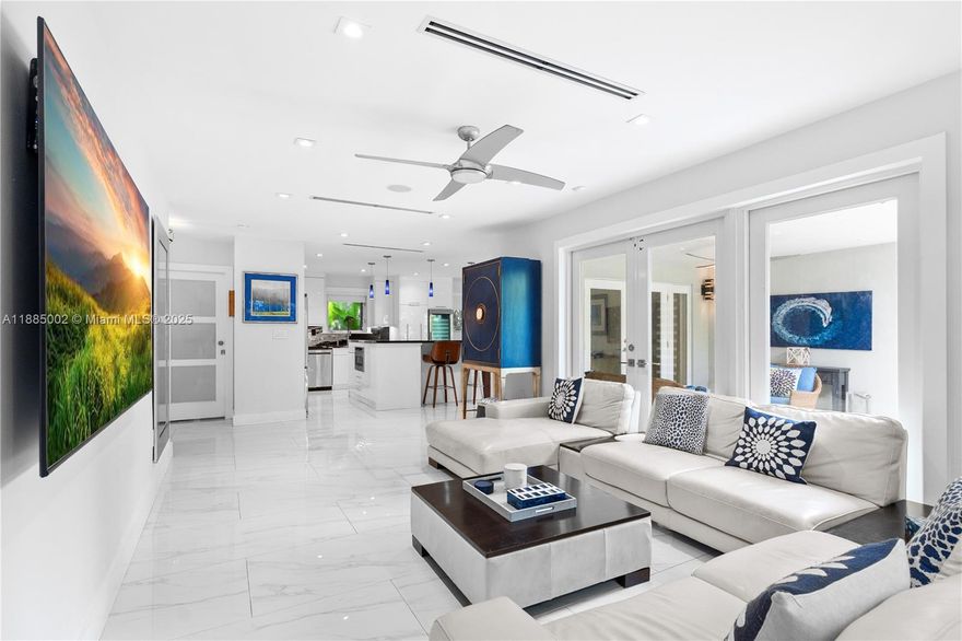 Exquisite turn-key Coral Gables 3 bed / 2 bath home plus den/office set on a tranquil, tree-lined street. This residence showcases sleek porcelain tile floors, a bright open kitchen with granite island, Viking appliances, gas range, and wine cooler. The en-suite master features a soaking tub and walk-in closet. French doors open to a private outdoor retreat with summer kitchen, lounge pool, hot tub, and waterfall. Perfect for entertaining! Additional highlights include impact windows and doors, lush landscaping with lighting, grey stone pavers, two-car garage, and newer roof. Ideally located just one block from Granada Golf Course & close to Salvatore Park & Biltmore Hotel, this extraordinary home sits on one of the best streets in the Gables.