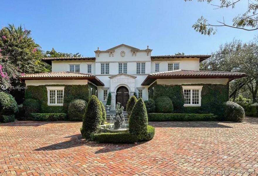 Enjoy La Dolce Vita in this Magnificent Italian inspired estate in Stonegate, a prestigious guard-gated enclave in Ponce-Davis. Timeless Mediterranean beauty welcomes one through impressive arched drs & a 2-story elegant foyer w/ double staircase. The classic floor plan frames the central courtyard w/ fountain bringing in natural light. The formal areas feature crown molding, trey & coffered ceilings, wine cellar & 4 fireplaces. Kitchen w/ cooking island & spacious breakfast rm overlook the pool. 3 BR & office downstairs plus 2 half baths. Upstairs there are 3 ensuite BR & private master suite w/ fireplace, separate dressing area & marble bath. An open balcony overlooks the pool & sumptuous tropical 3/4-acre garden. 3-car garage, full house generator. Community tennis court & playground.