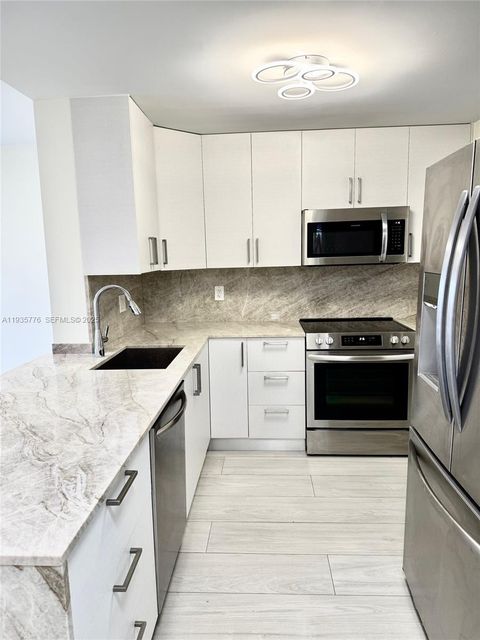 Photo of 401 Golden Isles Dr #701, Hallandale Beach, FL 33009 (MLS # A11935776)