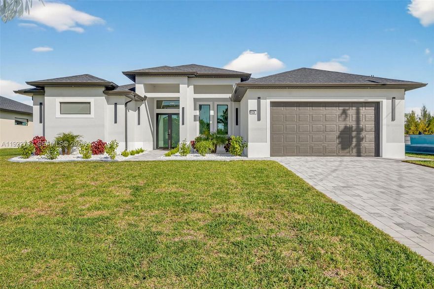 Beautiful, never-lived-in new construction luxury home on a freshwater canal in highly desirable SW Cape Coral. NOT IN A FLOOD ZONE and NO HOA! Thoughtfully designed with elegant landscaping and mature palms, this home welcomes you with soaring coffered tray ceilings and a stunning entertainment wall with mounted TV and electric fireplace. The desirable split floor plan includes 3 bedrooms, 3 baths, plus a flex room ideal as an office, den, or 4th bedroom.

The kitchen features custom cabinetry, generous storage, and quartz countertops. A large laundry room includes built-in cabinets, utility sink, and washer and dryer. The primary suite offers lanai access, dual walk-in closets with custom shelving, and a spa-style bath with walk-in shower, dual sinks, and anti-fog lighted mirrors. The second bedroom includes its own ensuite, perfect for guests.

Enjoy the screened lanai with pool and sun shelf, plus an outdoor kitchen with sink and wine refrigerator—ideal for entertaining. Furnishings are negotiable for easy move-in. High-end finishes include upgraded fans, multi-mode lighting, impact doors and windows, oversized tile flooring with membrane, and refined craftsmanship.

A second similar new construction home is available next door—perfect for investors or those wanting to live close by.