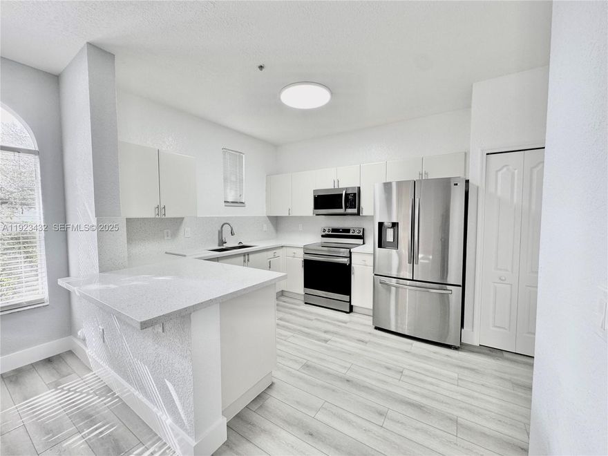 GATED COMMUNITY – Courtyards at Jacaranda in the heart of Plantation. Do not miss this fully updated 1st-floor residence featuring 3 Bedrooms / 2 Bathrooms with a bright and spacious open-concept layout. Recently painted, new vinyl flooring, and modern lighting throughout. The updated kitchen showcases quartz countertops and stainless-steel appliances—perfect for entertaining and everyday living.

Enjoy abundant natural light and ample space for family living or professional work-from-home needs. Prime community location with walking and running trails nearby, minutes from Jacaranda Golf Course. Top-rated schools. Close to Costco, major shopping malls, gourmet restaurants, entertainment, I-595, and Fort Lauderdale Airport. Ideal for families and professionals seeking comfort, convenience, and lifestyle.