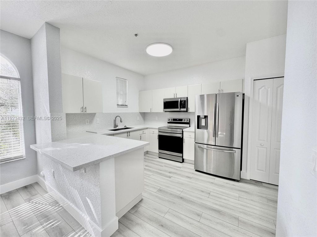 Photo of 120 Jacaranda Country Club Dr #101, Plantation, FL 33324 (MLS # A11923432)