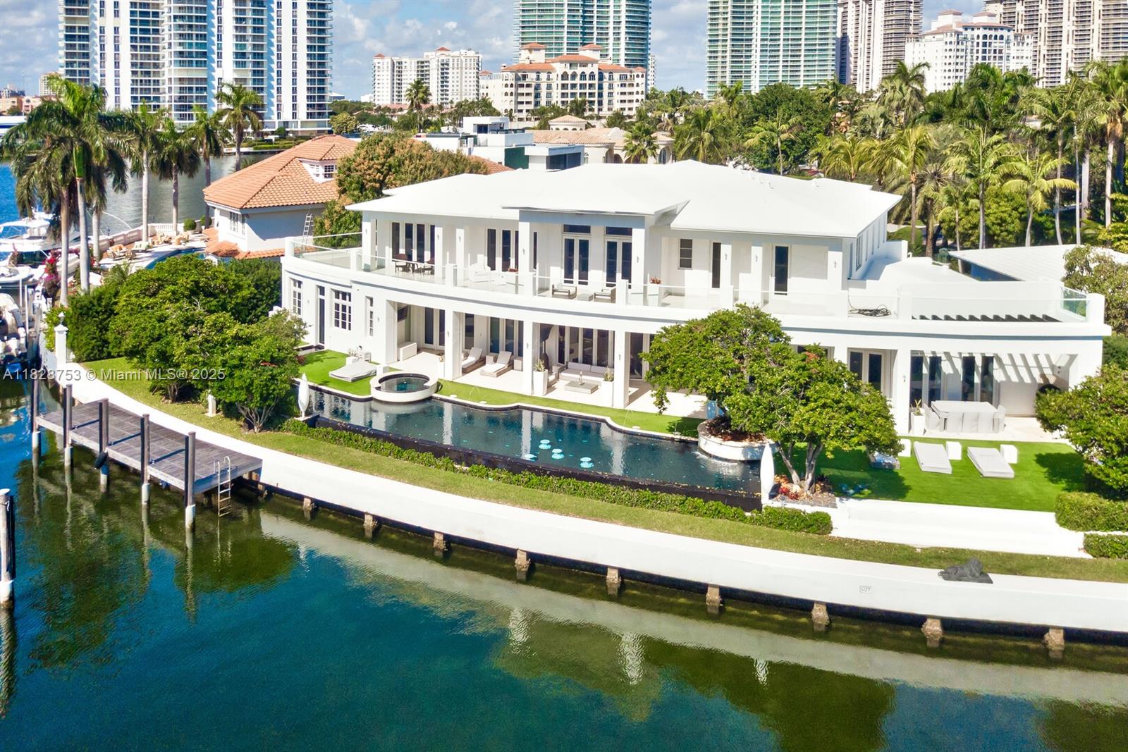 Set on an impressive 6-bedroom Golden Beach home with 186 feet of pristine waterfront, this impeccable estate home with its own private dock is truly a masterpiece. The manicured landscape features a 105’ indoor/outdoor infinity edge pool and integrated fountains. A grand double-staircase with vaulted ceilings welcomes you, backset by magnificent views along one of the widest bodies of water in Golden Beach. Interior features include a dedicated spa and fitness area, theater, wine cellar, elevator and expansive master suite with dual bathrooms and oversized wardrobes. Crestron automation, Kreon lighting, luxurious wall and window treatments, custom tapestries and top-quality finishes throughout will impress the most discerning buyers.