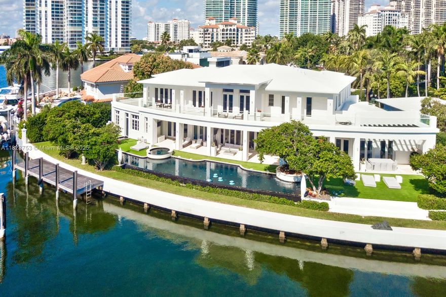Set on an impressive 6-bedroom Golden Beach home with 186 feet of pristine waterfront, this impeccable estate home with its own private dock is truly a masterpiece. The manicured landscape features a 105’ indoor/outdoor infinity edge pool and integrated fountains. A grand double-staircase with vaulted ceilings welcomes you, backset by magnificent views along one of the widest bodies of water in Golden Beach. Interior features include a dedicated spa and fitness area, theater, wine cellar, elevator and expansive master suite with dual bathrooms and oversized wardrobes. Crestron automation, Kreon lighting, luxurious wall and window treatments, custom tapestries and top-quality finishes throughout will impress the most discerning buyers.