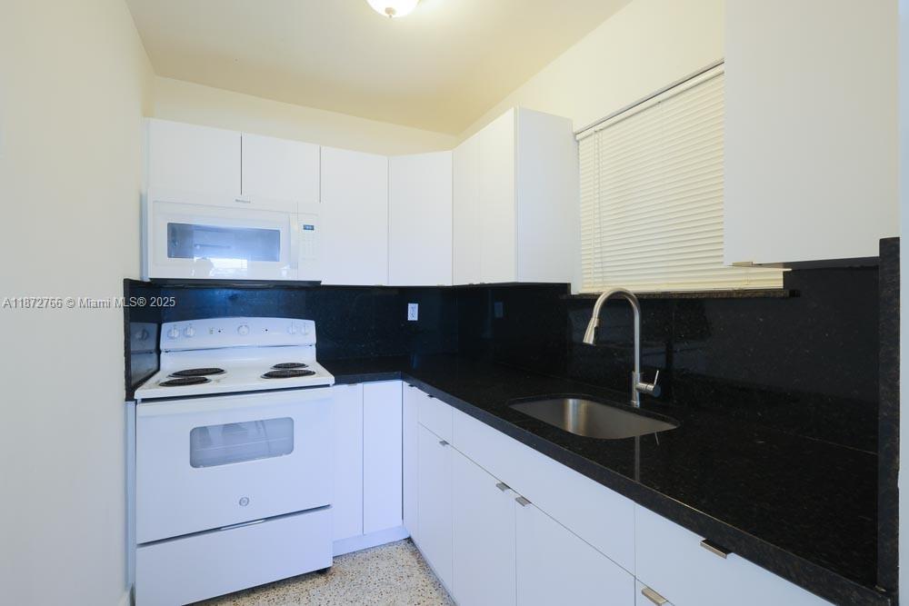 Spacious 2 bedroom on a second floor with a fantastic location for pleasant living. Renovated unit features polished terrazo floors and 3 newly installed central mini split AC units. Features new blinds in a well lit and airy, open building. The recently renovated kitchen includes granite counter tops, a full size fridge, a range/oven and a microwave. Plenty of kitchen storage in solid wood cabinets. One of the bedrooms features an outdoor balcony with a sliding glass door for enjoying the outdoors. Close to the airport, shopping and main roads with easy access to Downtown, Wynwood, Design District, Miami Beach, Little Havana, the apartment is near parks, beaches, restaurants and grocery stores. Includes one assigned parking spot, water and sewer. Visitor parking may be used for guests.