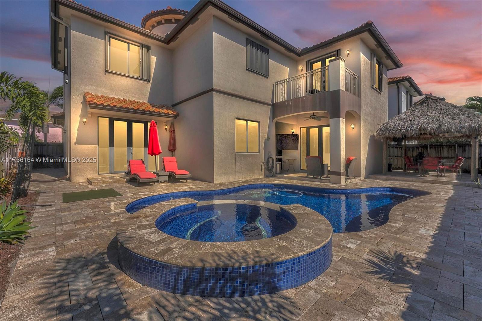 Welcome to your dream home at 14480 SW 22nd St — a stunning 5-bedroom, 4.5-bathroom estate in the heart of West Miami-Dade! With over 3,700 sq. ft. of elegant living space, this two-story masterpiece is designed to impress. Enjoy a grand formal living and dining room and a modern chef’s kitchen with state-of-the-art appliances and a wine cooler — perfect for entertaining. A downstairs bedroom offers convenience for guests or multi-generational living. The primary suite features a luxurious his-and-her bathroom and walk-in closets. Step outside to a resort-inspired backyard with a tiled pool, heated jacuzzi, and a charming Chiki hut — ideal for year-round relaxation and hosting. A 2-car garage and thoughtful layout complete this perfect home.