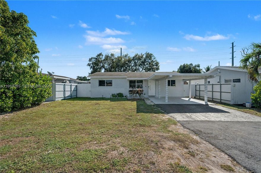 Beautifully remodeled one-story 3-bedroom, 2-bath CBS home offering modern upgrades, comfort, and long-term durability. This truly move-in-ready residence features a new roof, new A/C, and 24x24 tile flooring throughout, complemented by a bright, modern interior with quality finishes.

Enjoy peace of mind with new impact windows and impact doors by ECO Window Systems (KC-certified), providing excellent energy efficiency and storm protection. Major electrical upgrades include a new Siemens electrical panel, brand-new subterranean electrical service, recent underground power cables, and complete whole-house rewiring, enhancing safety and reliability.

The kitchen is equipped with Samsung stainless steel appliances, while the laundry area includes a Whirlpool washer and dryer. The home also features a newer Aquafil water treatment system. The property is currently on septic, includes a new septic tank lid for easier access, and municipal sewer connection is anticipated within approximately one year, offering future value.

Exterior highlights include a fully fenced backyard with white metal fencing, a storage shed, and a large covered patio with a wood-beam, open-air roof that stays naturally cool, ideal for entertaining. Spacious front and back yards and a carport complete the property.

Conveniently located near beaches, Hard Rock Hotel & Casino, shopping malls, dining, parks, and major airports.

Qualifies for FHA, VA, and Conventional financing.