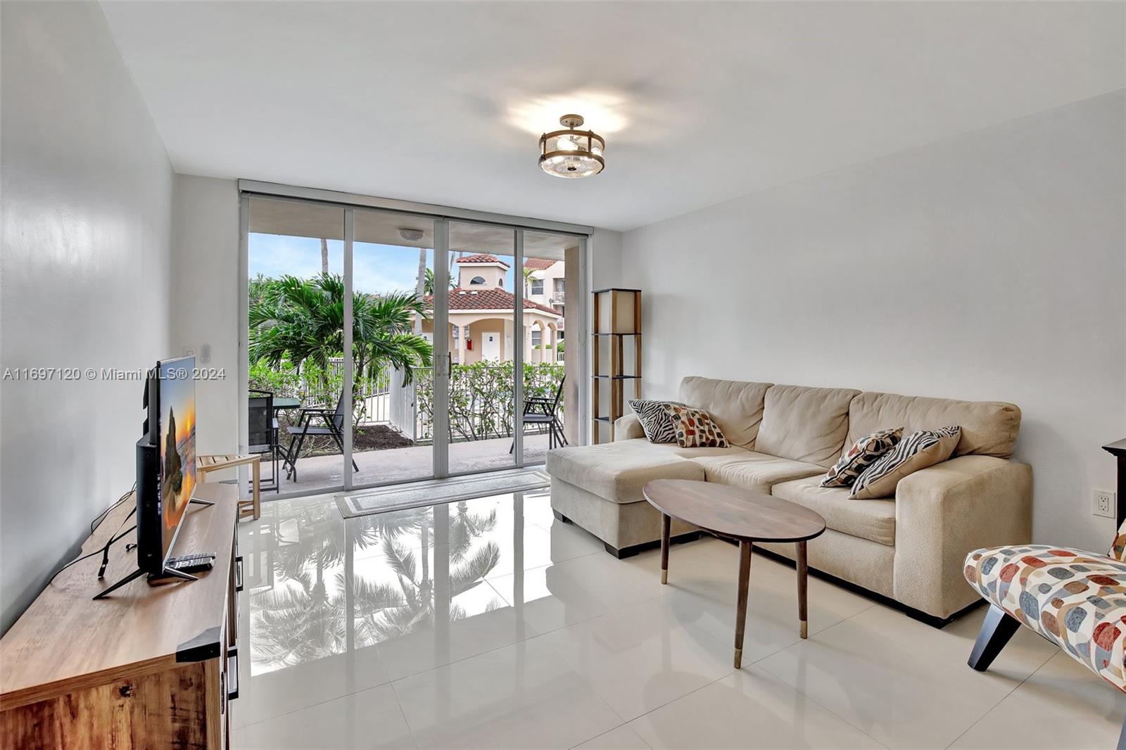 Wow, this is the one you have been waiting for! Fully updated, move in ready 2/2 with beautiful modern updates and just a short bike ride to Hollywood Beach. Split floor plan with gorgeous white porcelain tiles throughout. Large primary suite with a generously sized walk-in closet and redone bathroom. The kitchen and pantry have been totally upgraded with all new appliances. The refrigerator, dishwasher and washer/dryer come with a transferrable 5-year warranty. The hot water and A/C Units were installed in 2020. The spacious second bedroom includes built-in closet storage and updated bathroom. The patio offers an amazing view of the pool and more storage for all those miscellaneous outdoor items. The patio is only steps from your private parking spot and the list goes on. 10 Min. to FLL.
